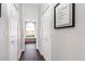 Hallway with wood floors, linen closets and a view of the main bath at 2037 Blue River Rd, Holiday, FL 34691