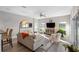 Comfortable living room with sliding glass door to lanai, ceiling fan, and kitchen in background at 2037 Blue River Rd, Holiday, FL 34691