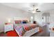 Spacious main bedroom featuring wood floors, a ceiling fan, and an ensuite bathroom at 2037 Blue River Rd, Holiday, FL 34691