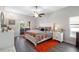 Main bedroom with sliding door access to lanai, ceiling fan, and neutral decor at 2037 Blue River Rd, Holiday, FL 34691