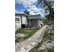 View of a portion of the home's backyard with an outdoor shed and walkway at 2102 W Ivy St, Tampa, FL 33607