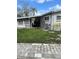 View of the back exterior of this one-story home and carport at 2102 W Ivy St, Tampa, FL 33607