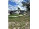 A partial view of the home's exterior with a brick walkway and surrounding lawn at 2102 W Ivy St, Tampa, FL 33607