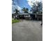 An eye-level view of the front of this one-story home and the driveway and carport at 2102 W Ivy St, Tampa, FL 33607