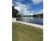 Picturesque waterfront view featuring a tranquil canal and scenic shoreline, framed by a green lawn and bright sky at 2102 W Ivy St, Tampa, FL 33607