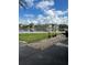 Stunning waterfront view featuring a calm canal, lush green lawn, and a paver patio with decorative plants at 2102 W Ivy St, Tampa, FL 33607