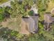 Aerial view of property with a brown roof and lush, mature landscaping with trees and palms at 2151 E Leewynn Dr, Sarasota, FL 34240