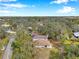 Aerial view of the house and its surroundings with lush greenery at 2151 E Leewynn Dr, Sarasota, FL 34240