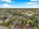 Aerial view of a house in a lush area with a road and blue sky at 2151 E Leewynn Dr, Sarasota, FL 34240