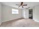 A bright bedroom with plush carpet and an updated ceiling fan at 2151 E Leewynn Dr, Sarasota, FL 34240