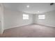 Bedroom featuring neutral carpeting and two large windows providing natural light at 2151 E Leewynn Dr, Sarasota, FL 34240