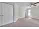 Bright bedroom features plush carpet, ceiling fan, and a closet for ample storage at 2151 E Leewynn Dr, Sarasota, FL 34240