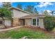 Two story home featuring a stone facade, bay window, manicured lawn, with some mature landscaping at 2151 E Leewynn Dr, Sarasota, FL 34240