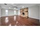 Spacious living room featuring wood floors, a ceiling fan and a stone fireplace at 2151 E Leewynn Dr, Sarasota, FL 34240