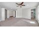 Spacious main bedroom featuring a ceiling fan, ensuite bath, double closets, and plush carpeting at 2151 E Leewynn Dr, Sarasota, FL 34240