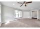 Spacious main bedroom featuring a bay window, double closets, plush carpet, and neutral paint at 2151 E Leewynn Dr, Sarasota, FL 34240