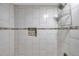 Walk-in shower with shower caddy and tiled accent wall at 2151 E Leewynn Dr, Sarasota, FL 34240