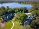 Aerial view showcasing the community center, surrounding trees, and the beautiful lake in the background at 21537 Draycott Way, Land O Lakes, FL 34637