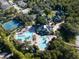 Community amenities including a pool, tennis courts, and clubhouse, surrounded by lush greenery at 21537 Draycott Way, Land O Lakes, FL 34637