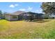 Sprawling backyard featuring a screened-in pool and outdoor entertaining space at 21537 Draycott Way, Land O Lakes, FL 34637