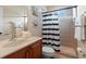 Well-lit bathroom featuring a shower with curtain, a toilet, towels, and a sink with cabinets for convenience and style at 21537 Draycott Way, Land O Lakes, FL 34637