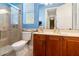 Bright bathroom featuring a glass-enclosed shower, decorative rope, vanity with wood cabinets, and a toilet for convenience at 21537 Draycott Way, Land O Lakes, FL 34637