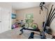 Bright bonus room featuring home gym equipment and a mounted television for entertainment at 21537 Draycott Way, Land O Lakes, FL 34637