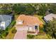 Beautiful two-story home with a well-manicured lawn and brick driveway at 21537 Draycott Way, Land O Lakes, FL 34637