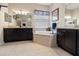 Elegant bathroom with a soaking tub, dark wood cabinets, dual sinks, and decorative mirrors at 21537 Draycott Way, Land O Lakes, FL 34637