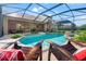 Backyard swimming pool and spa area with chairs for relaxing at 21537 Draycott Way, Land O Lakes, FL 34637