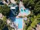 Aerial view of a large community pool area, featuring multiple pools and a deck with seating at 21537 Draycott Way, Land O Lakes, FL 34637