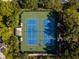 Aerial view of well-maintained tennis courts, ready for a match in a serene setting at 21537 Draycott Way, Land O Lakes, FL 34637