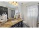 Stylish bathroom featuring granite countertops, decorative jars, and elegant black and white accents at 2359 Emerald Lake Dr, Sun City Center, FL 33573