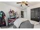 Cozy bedroom featuring a unique dollhouse, ceiling fan, and comfortable bedding at 2359 Emerald Lake Dr, Sun City Center, FL 33573