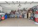 Garage with epoxy floor, shelving, and tool storage at 2359 Emerald Lake Dr, Sun City Center, FL 33573