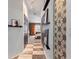 Hallway view leading to a bedroom, featuring stylish floors and wall decor at 2359 Emerald Lake Dr, Sun City Center, FL 33573