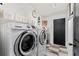 Laundry room with front load Samsung washer and dryer, cabinets, and patterned flooring at 2359 Emerald Lake Dr, Sun City Center, FL 33573