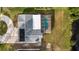 Overhead view of a property featuring a pool and screen enclosure next to a pond at 239 Freeport Ne Ave, St Petersburg, FL 33702