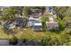 Aerial view of a home and backyard featuring a pool and pond near neighborhood at 239 Freeport Ne Ave, St Petersburg, FL 33702