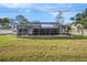 A beautiful home featuring a pool with a screened enclosure and a lush green yard at 239 Freeport Ne Ave, St Petersburg, FL 33702