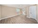 An empty bedroom with neutral walls, wood-look floors, two windows, and a door at 239 Freeport Ne Ave, St Petersburg, FL 33702