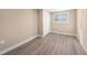 An empty bedroom with neutral walls, wood-look floors, a window, and a closet at 239 Freeport Ne Ave, St Petersburg, FL 33702