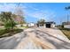 Charming single-story home with a brick facade, black trim, well-maintained lawn and long driveway at 239 Freeport Ne Ave, St Petersburg, FL 33702