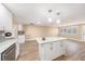 An open kitchen area that features an island, pendant lighting and stainless steel appliances at 239 Freeport Ne Ave, St Petersburg, FL 33702