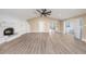 Spacious living room featuring laminate floors, fireplace, high ceilings and lots of natural light at 239 Freeport Ne Ave, St Petersburg, FL 33702