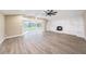 Bright living room featuring laminate floors, fireplace, large window, and a vaulted ceiling at 239 Freeport Ne Ave, St Petersburg, FL 33702