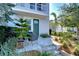 Inviting front entrance features a cozy seating area, lush landscaping, and a charming green front door at 2510 W Cleveland St # 3, Tampa, FL 33609