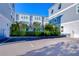 Charming exterior view of blue townhomes with well-maintained landscaping and ample parking at 2510 W Cleveland St # 3, Tampa, FL 33609