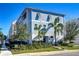 Beautiful blue three-story townhome boasts elegant shutters, well-maintained landscaping, and is conveniently located on a corner lot at 2510 W Cleveland St # 3, Tampa, FL 33609