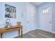 Bright foyer features beautiful wood-look floors, a stylish console table, and a door with glass panels at 2510 W Cleveland St # 3, Tampa, FL 33609